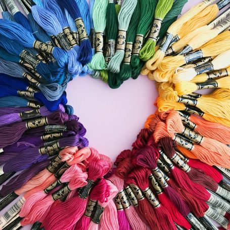 colourful yarn placed in the shape of a heart