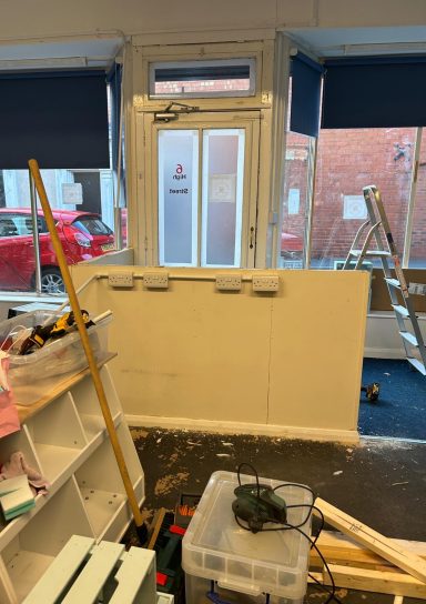 During: Front door. During: The wall blocking the door has been halved in height, creating a walkway from the door into the shop.