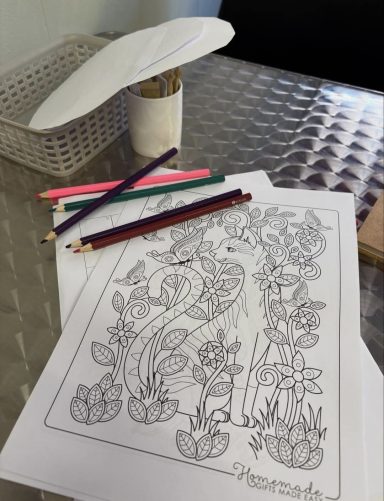 Colouring sheet. Example of colouring pages with some colouring pencils, this page is a cat with flowers.